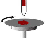 Material such as photoresist being dispensed and spin coated onto a wafer