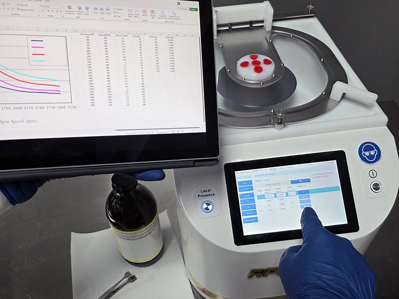 An operator using the Cee® Apogee Spin Coating system.
