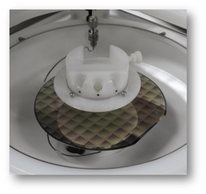 A photograph offered by Cost Effective Equipment demonstrating how back-side rinse is facilitated on an Apogee Spin Developer/Cleaner.
