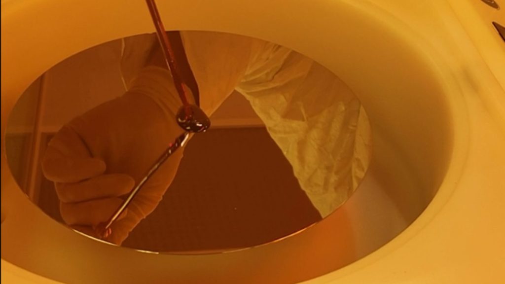 An image of manual dispense being performed on an Apogee® Spin Coater