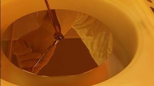 An image of manual dispense being performed on an Apogee® Spin Coater