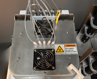 A photograph of a custom Cee® Apogee® UV Cure Spin Coater